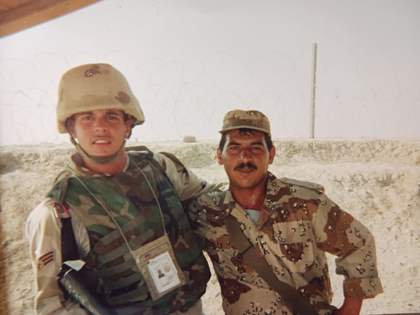 Brandon in desert camouflage with a fellow service member
