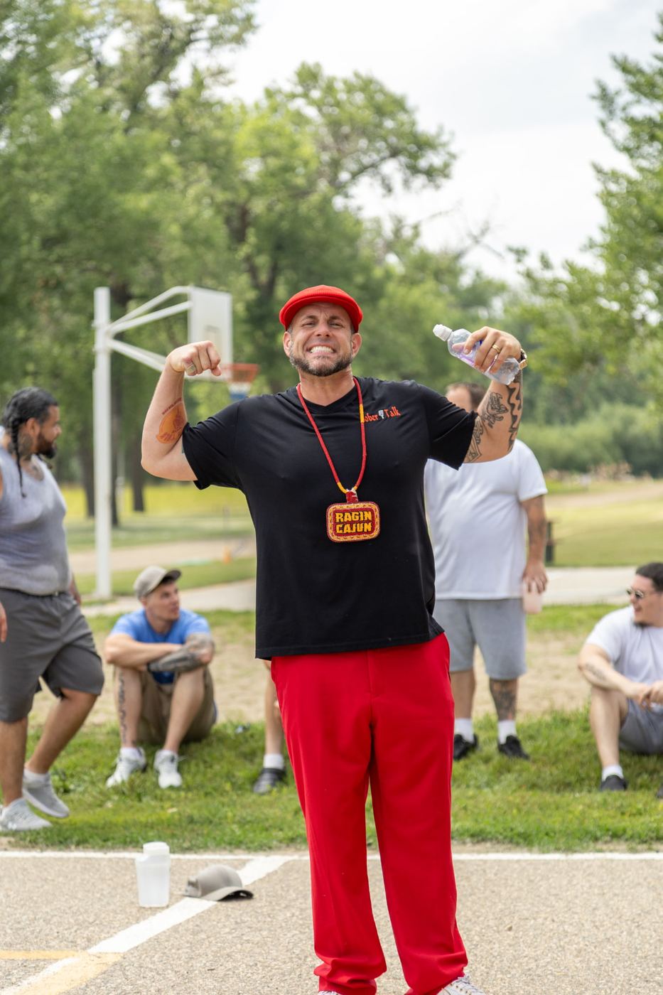 Brandon in a SoberTalk shirt and medallion at an outdoor gathering