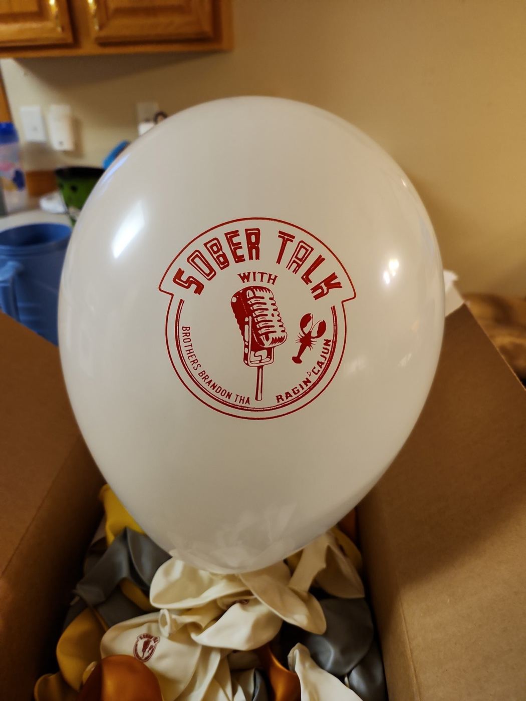 A white SoberTalk balloon with the mic logo